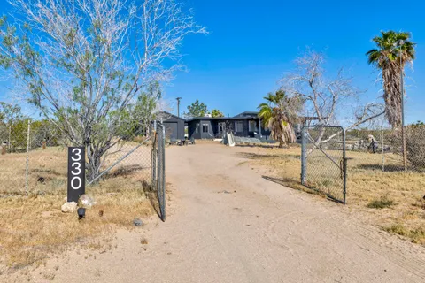 a view of a yard with snow on the road
