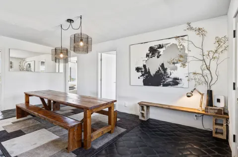 a living room with table and chairs