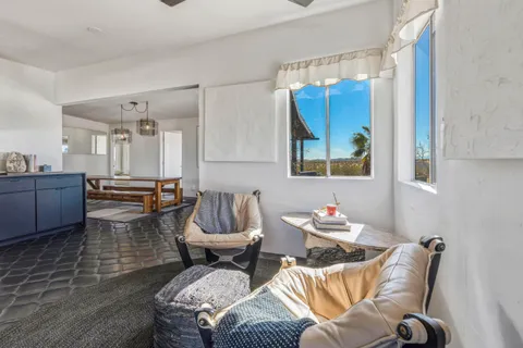 a living room with furniture and a mirror