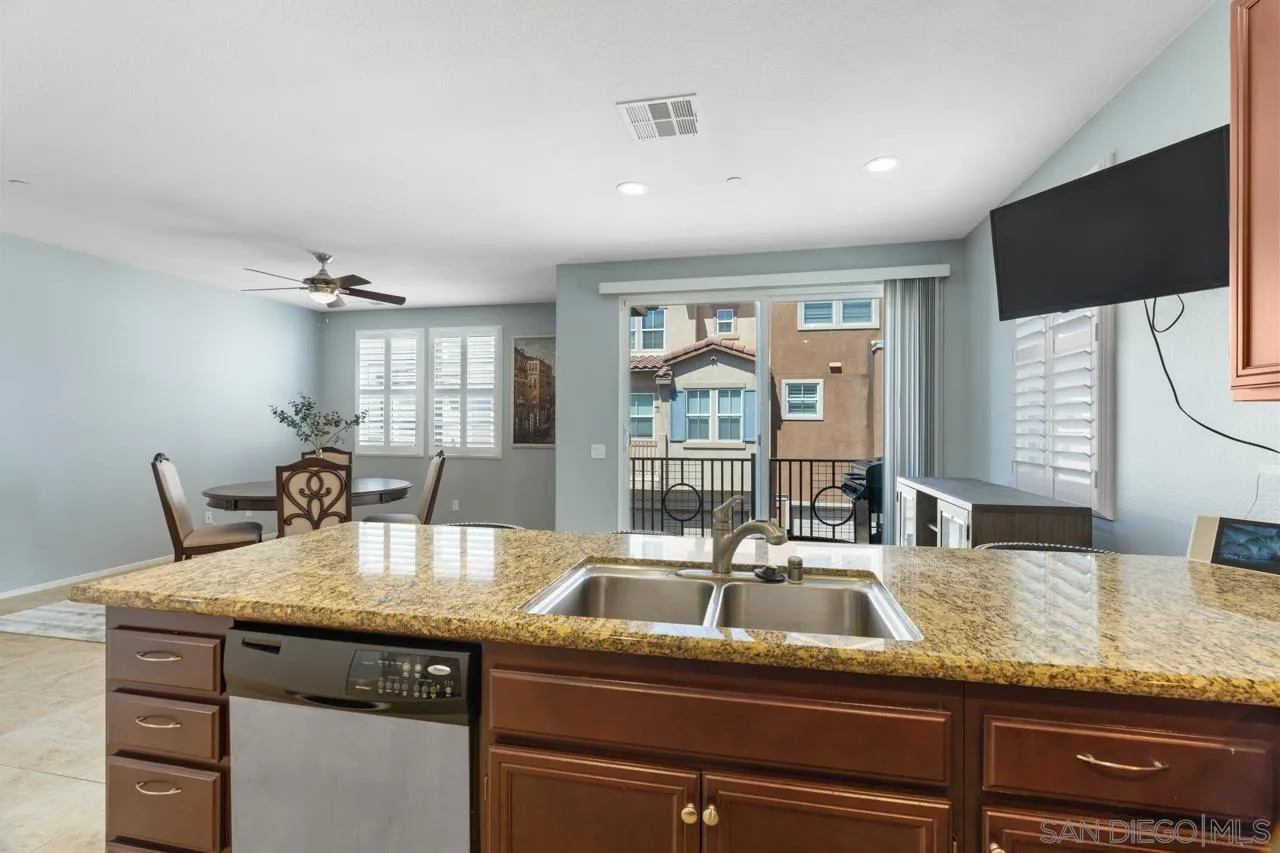 9811 Old Tree Lane Santee, CA 92071 - Photo 12 of 45 a kitchen with granite countertop a sink and a wooden floor