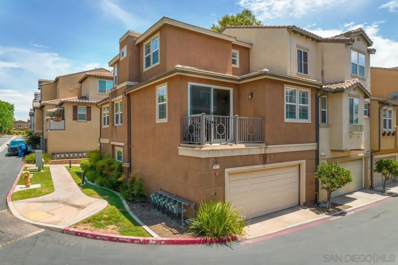 9811 Old Tree Lane Santee, CA 92071 - Photo 2 of 45 a view of a white house with large windows and plants