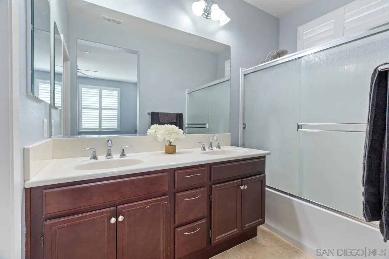 9811 Old Tree Lane Santee, CA 92071 - Photo 23 of 45 a bathroom with a double vanity sink and mirror