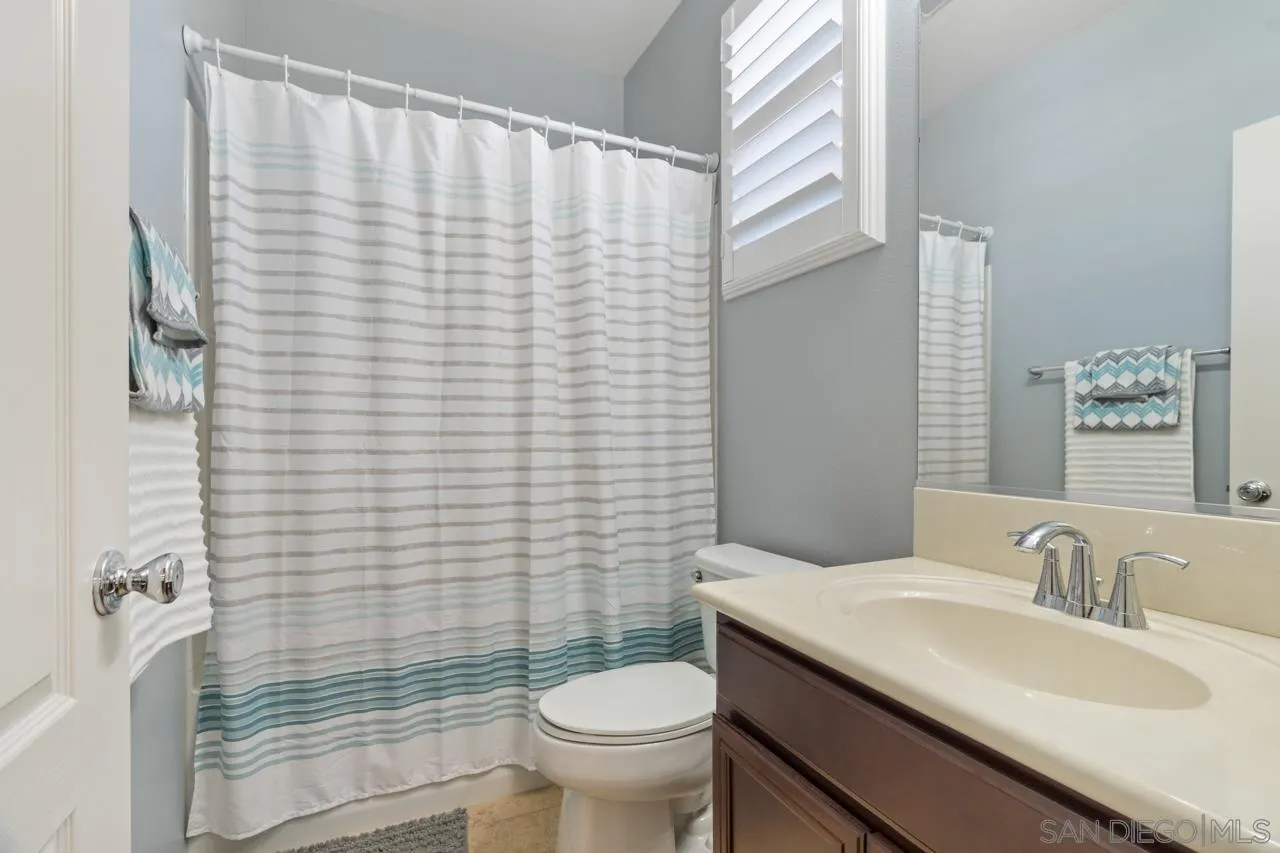 9811 Old Tree Lane Santee, CA 92071 - Photo 26 of 45 a bathroom with a granite countertop sink toilet and shower