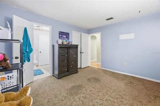 a view of a bedroom with furniture and closet