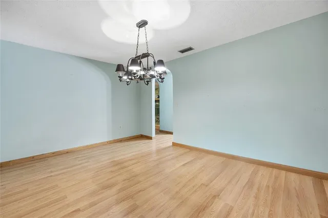 a kitchen with stainless steel appliances granite countertop a refrigerator a sink a stove and oven