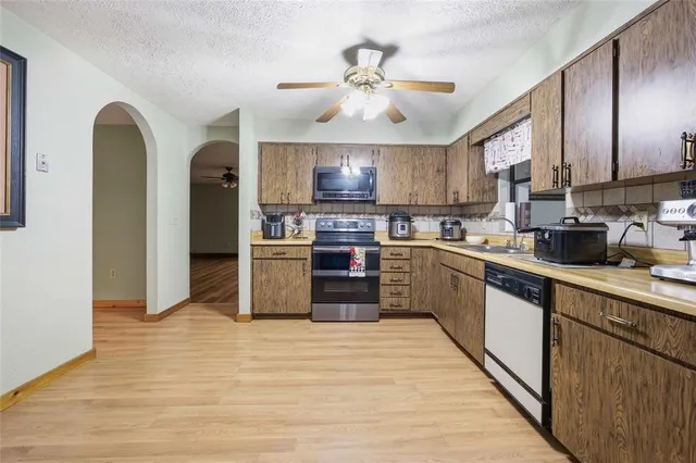 a kitchen with a stove a sink and a microwave