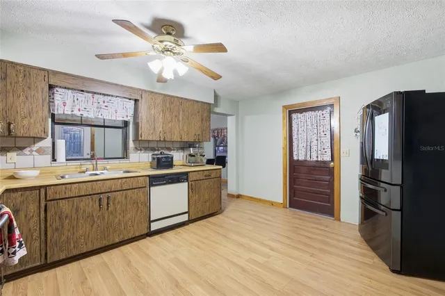 a view of a livingroom with workspace and a window