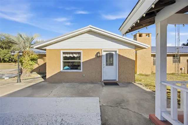 a swimming pool with outdoor seating and yard