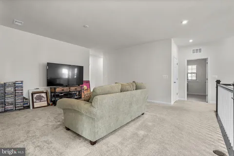 a spacious bedroom with a bed and a flat screen tv