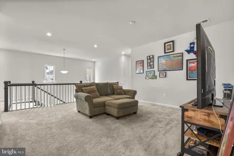 a view of walk in closet with clothes