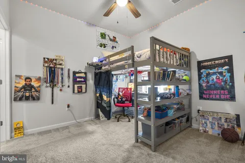 a bedroom with a bed and a desk