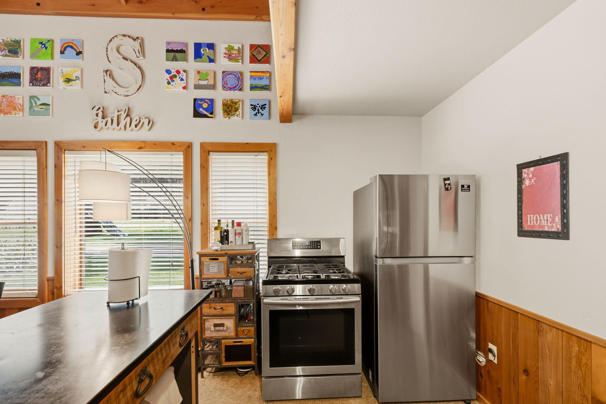 985 Elliott Creek Road Wilderville, OR 97543 - Photo 67 of 98 a kitchen with stainless steel appliances a refrigerator a sink and a stove with wooden floor