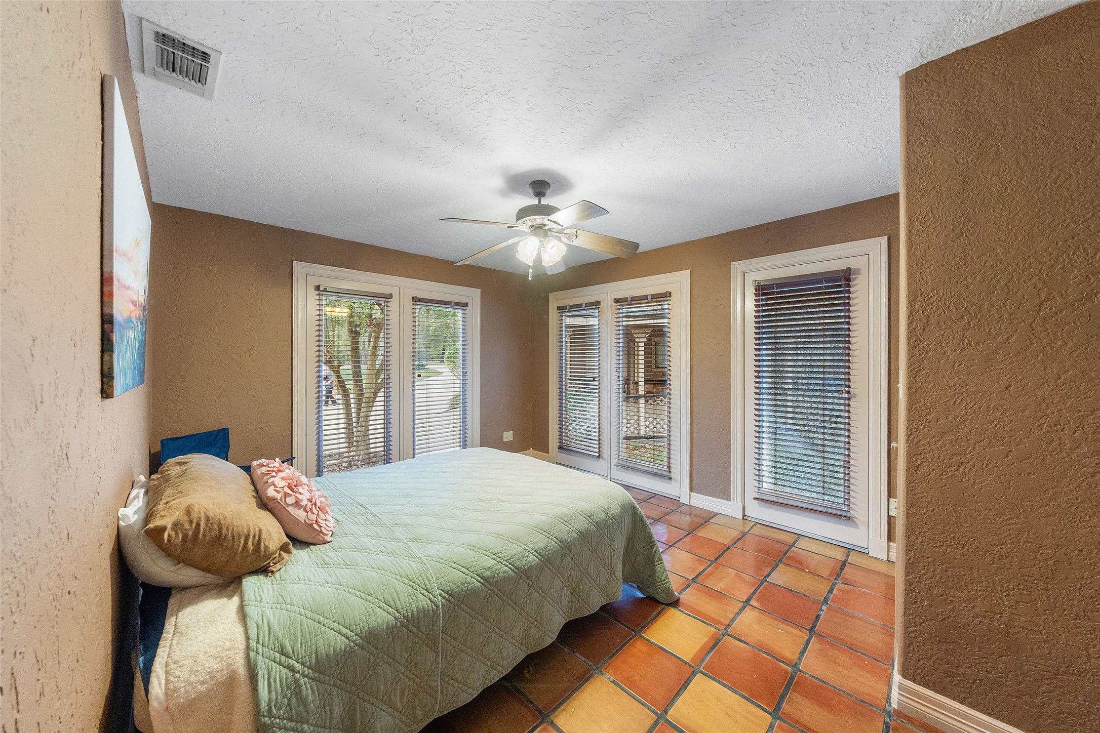 186 Lake Road Huntsville, TX 77320 - Photo 15 of 48 a bedroom with a bed and a chandelier