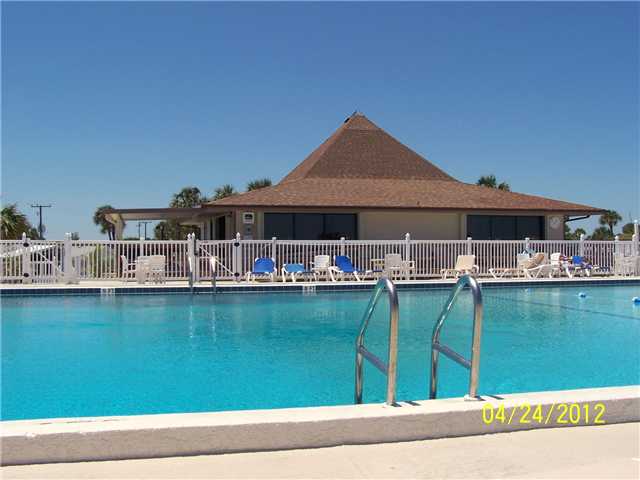 5301 Ebbtide Way Fort Pierce, FL 34949 - Photo 14 of 14 a view of a swimming pool with lawn chairs and a table