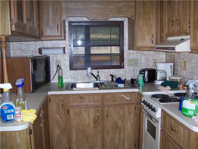 5301 Ebbtide Way Fort Pierce, FL 34949 - Photo 4 of 14 a kitchen with stainless steel appliances granite countertop a sink stove and cabinets