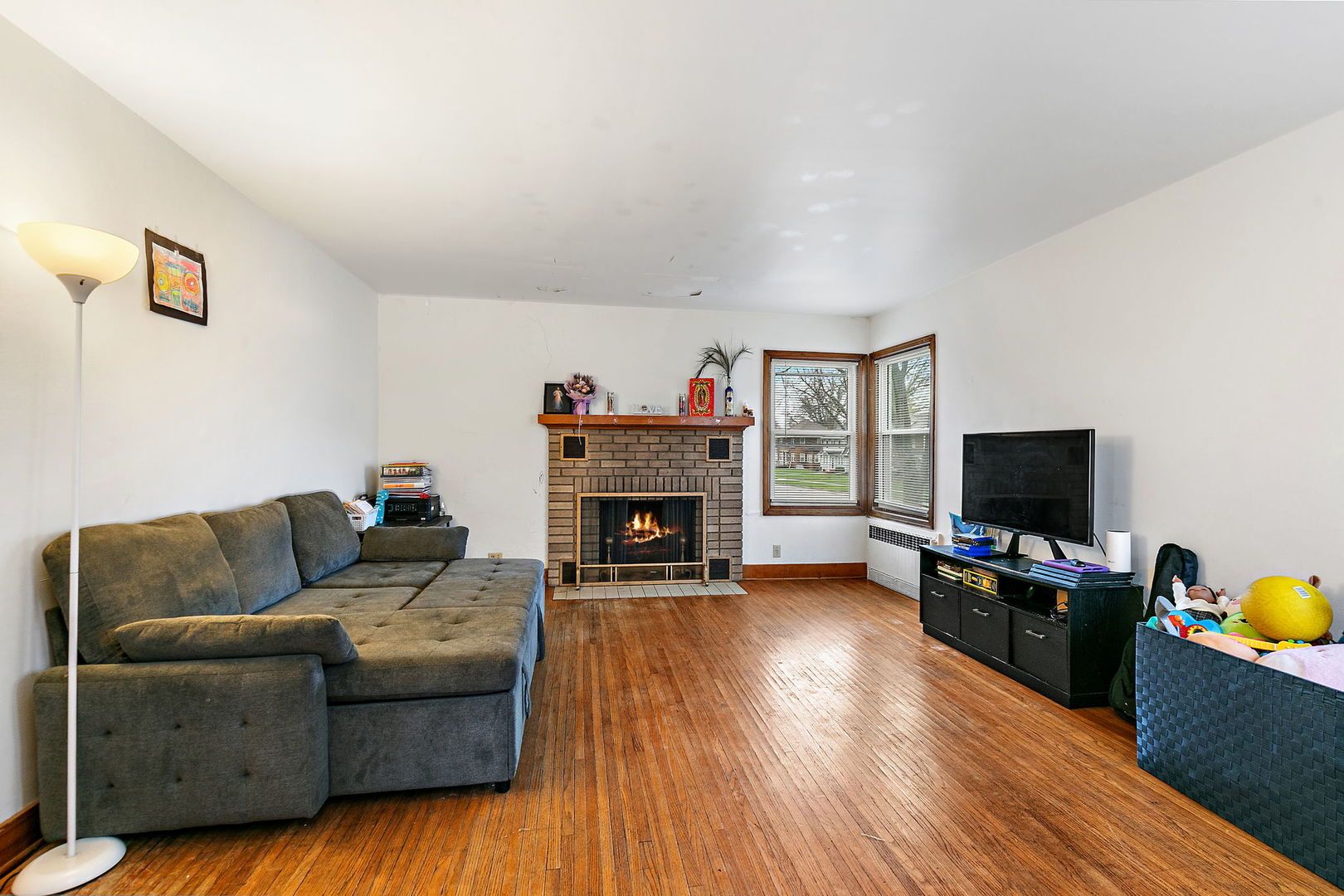 820 Lincoln Highway Rochelle, IL 61068 - Photo 15 of 27 a living room with furniture a flat screen tv and a fireplace