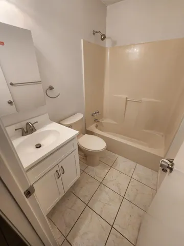a bathroom with a sink mirror and toilet