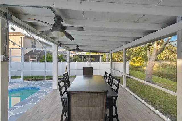 a kitchen with stainless steel appliances granite countertop a refrigerator a sink dishwasher a stove and a dining table with wooden floor