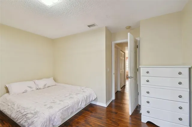 a bathroom with a granite countertop sink a toilet a mirror and shower