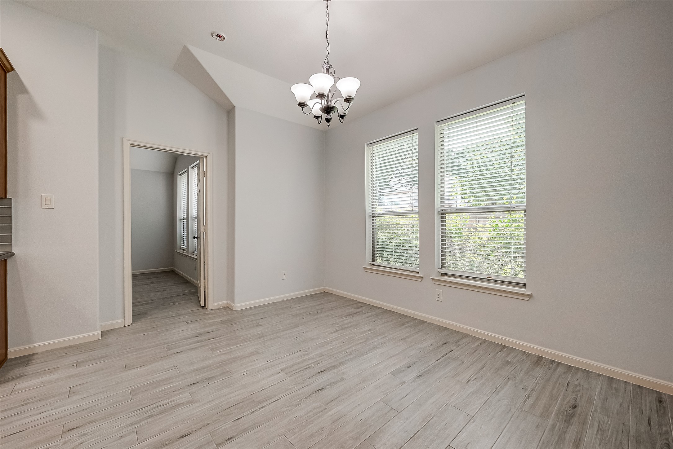 18302 North Elizabeth Shore Loop Cypress, TX 77433 - Photo 11 of 41 a view of an empty room with a window and wooden floor