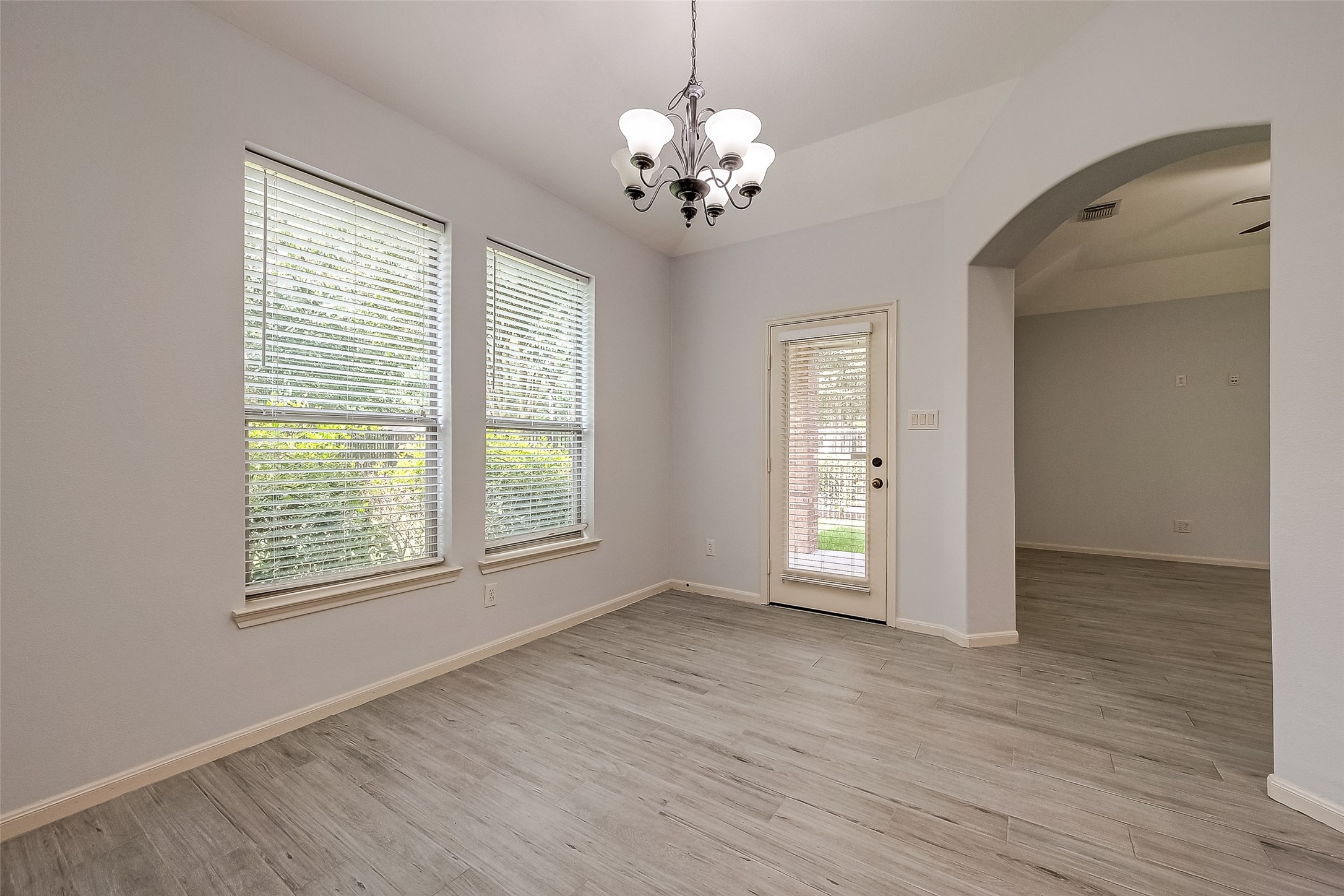 18302 North Elizabeth Shore Loop Cypress, TX 77433 - Photo 14 of 41 a view of an empty room with wooden floor and a window