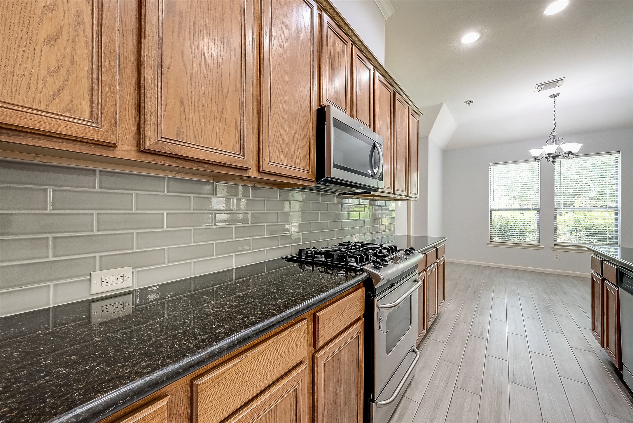 18302 North Elizabeth Shore Loop Cypress, TX 77433 - Photo 18 of 41 a kitchen with stainless steel appliances granite countertop a stove a sink and a microwave