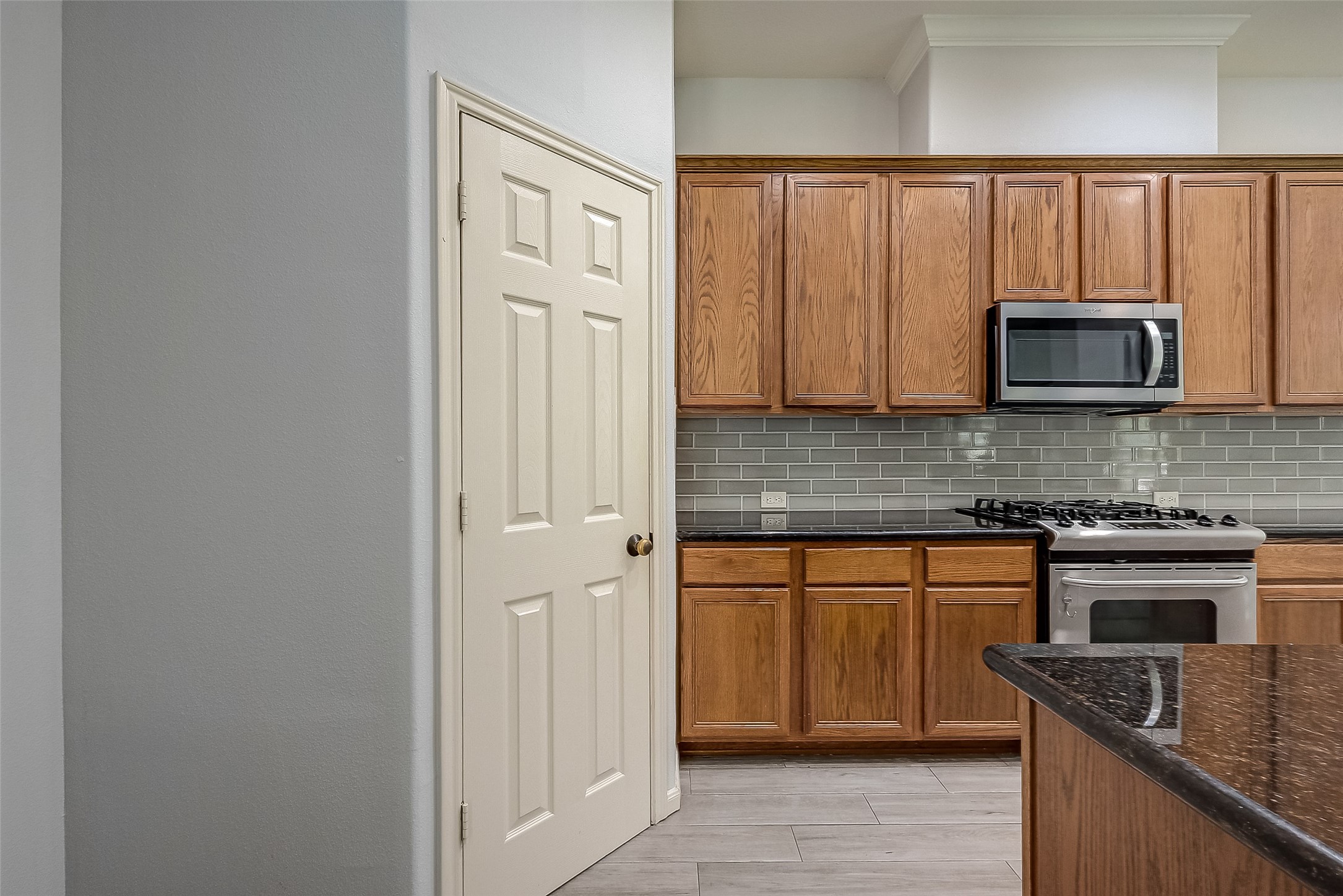 18302 North Elizabeth Shore Loop Cypress, TX 77433 - Photo 21 of 41 a kitchen with stainless steel appliances granite countertop a stove microwave and sink