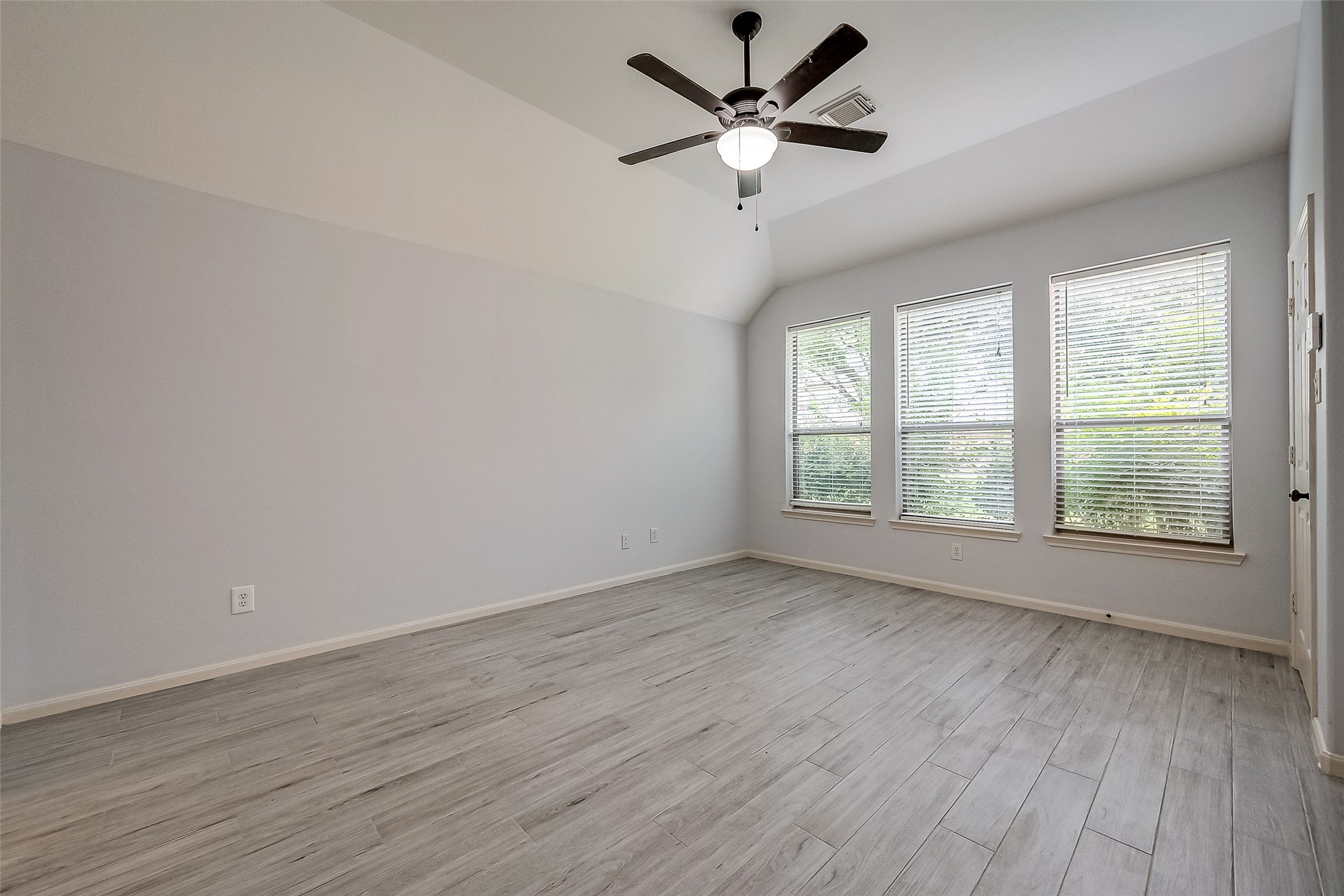 18302 North Elizabeth Shore Loop Cypress, TX 77433 - Photo 25 of 41 an empty room with wooden floor fan and windows