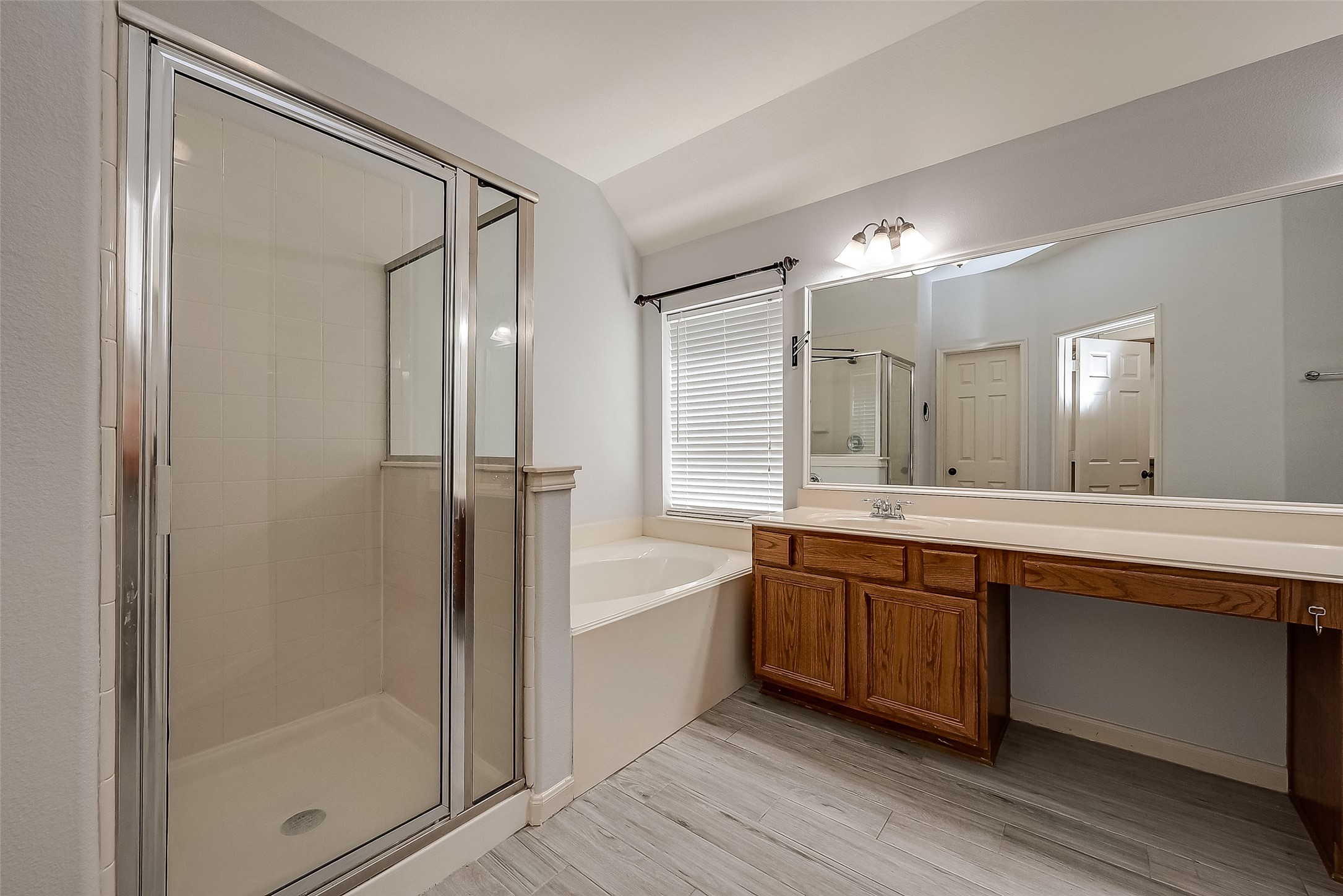 18302 North Elizabeth Shore Loop Cypress, TX 77433 - Photo 28 of 41 a large bathroom with a double vanity sink a large mirror and shower