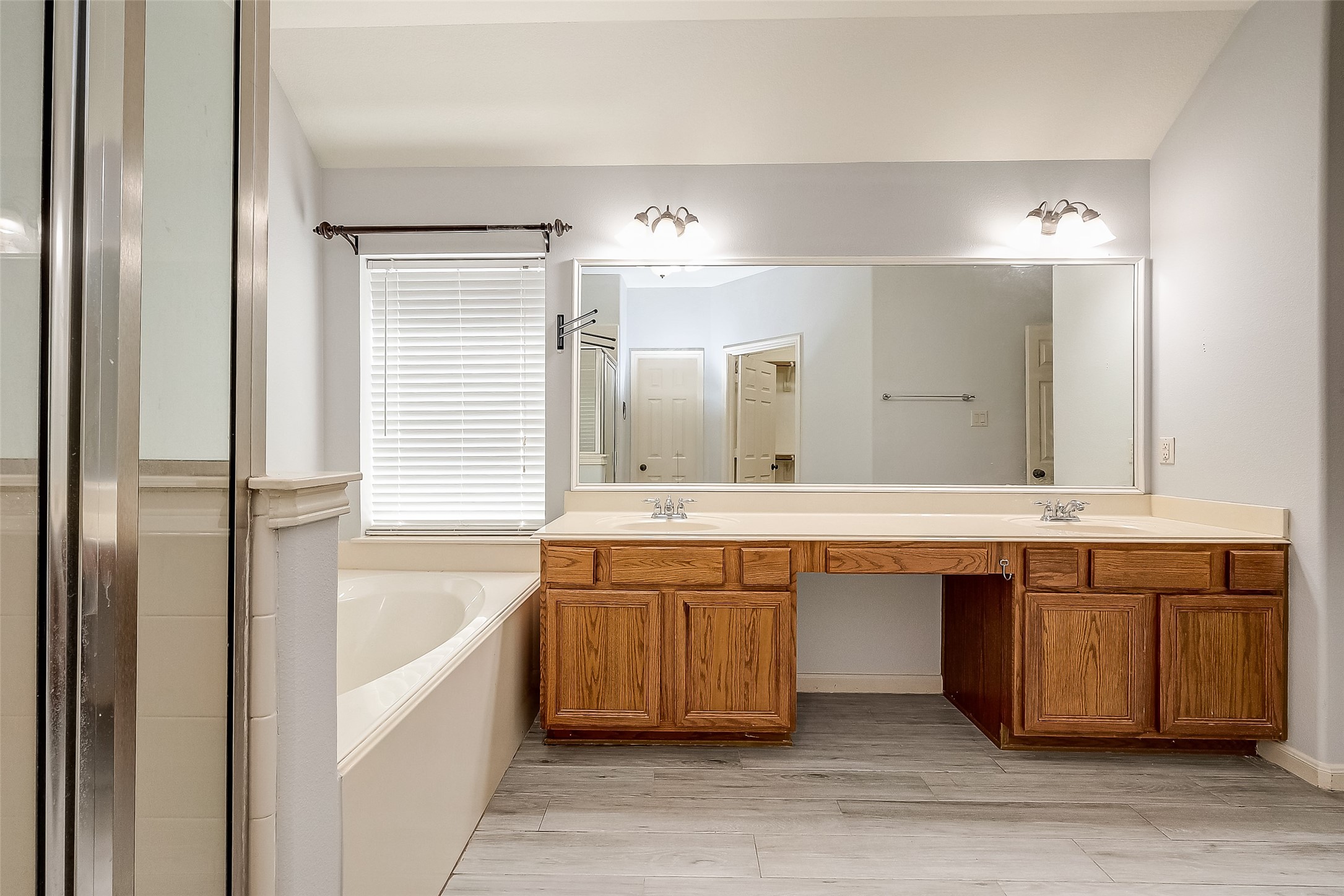 18302 North Elizabeth Shore Loop Cypress, TX 77433 - Photo 29 of 41 a bathroom with a tub double vanity sink and a large mirror