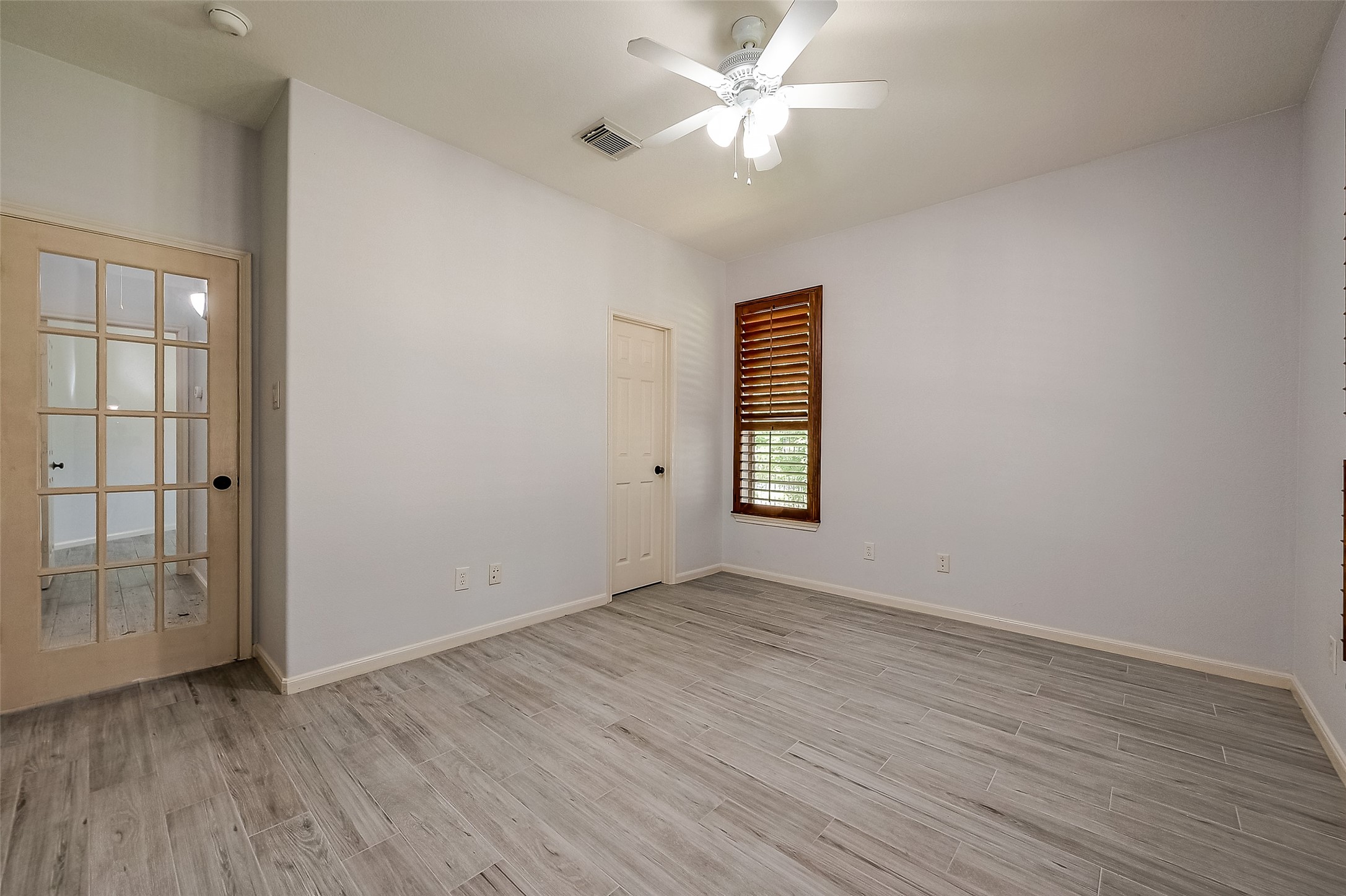 18302 North Elizabeth Shore Loop Cypress, TX 77433 - Photo 32 of 41 an empty room with wooden floor closet and windows