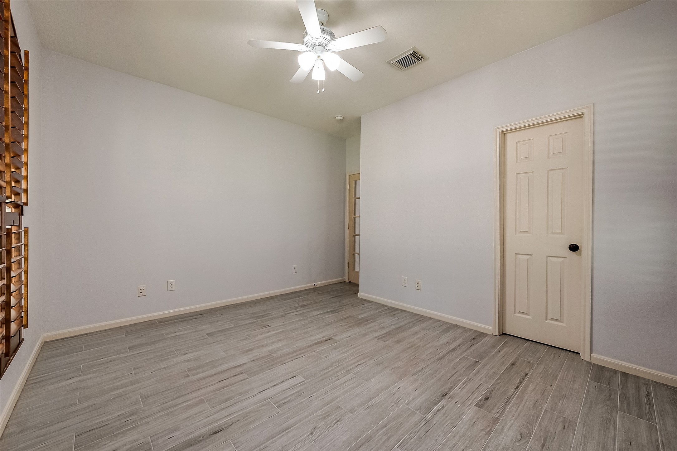 18302 North Elizabeth Shore Loop Cypress, TX 77433 - Photo 33 of 41 a view of an empty room with wooden floor