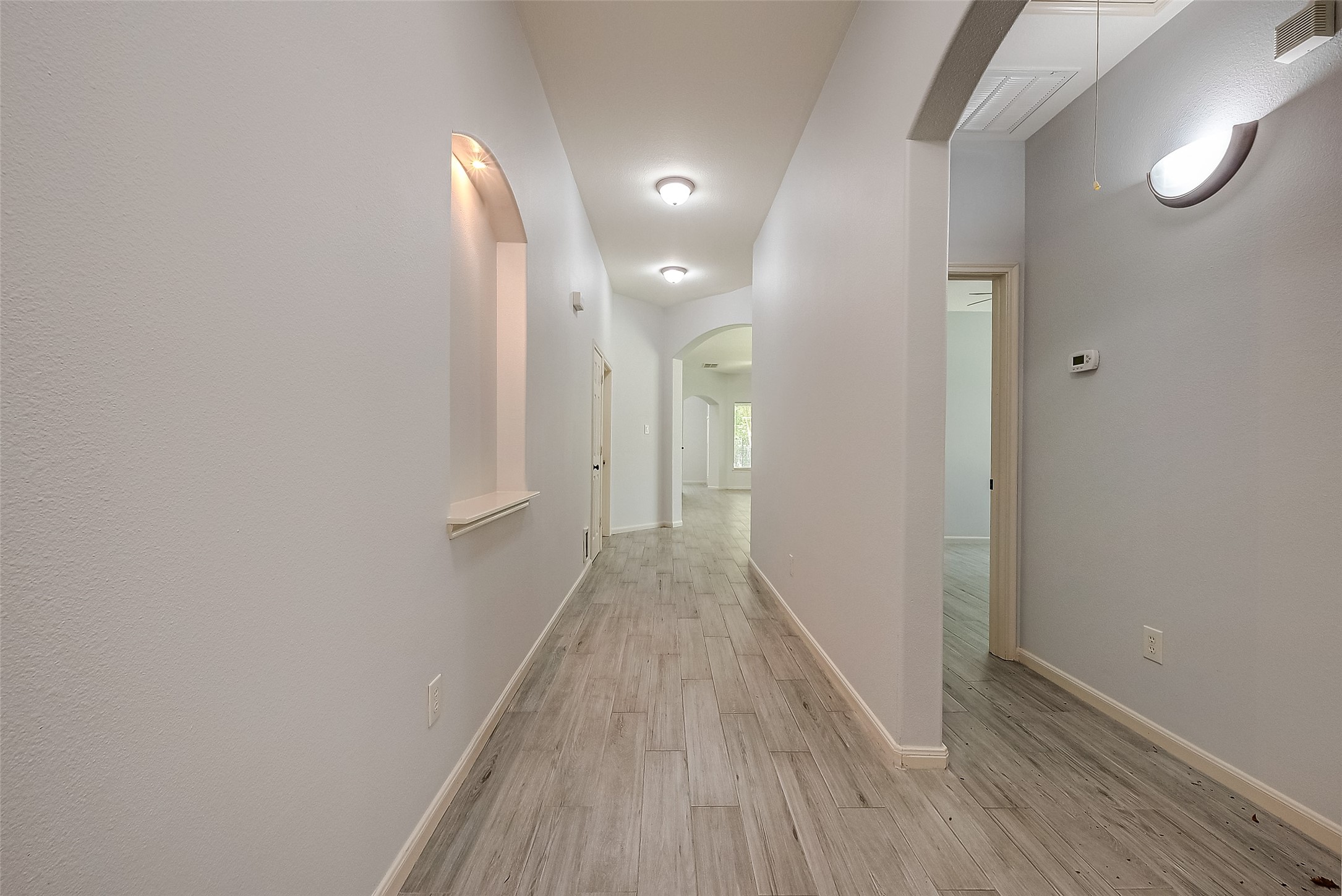 18302 North Elizabeth Shore Loop Cypress, TX 77433 - Photo 5 of 41 a view of a hallway with wooden floor