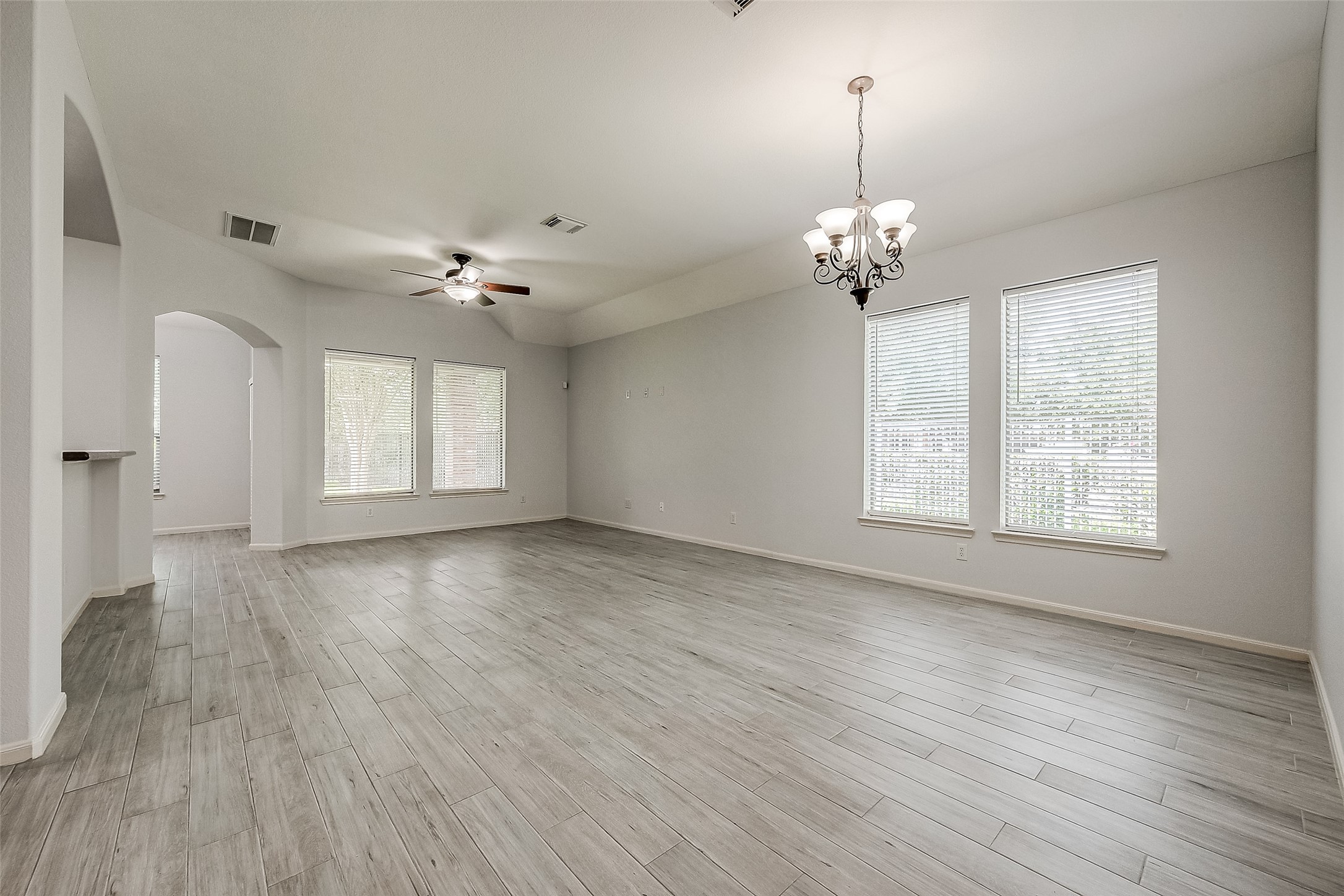 18302 North Elizabeth Shore Loop Cypress, TX 77433 - Photo 7 of 41 a view of an empty room with a window and wooden floor