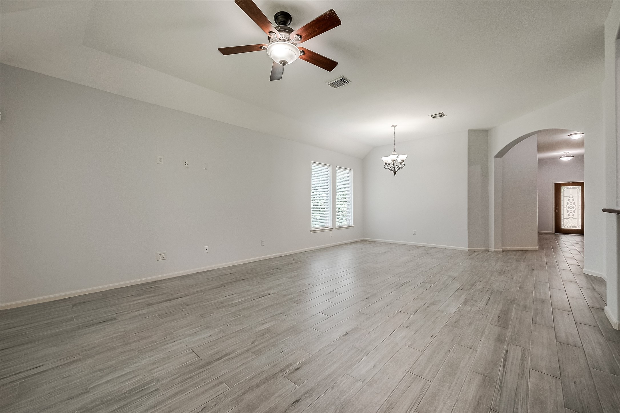 18302 North Elizabeth Shore Loop Cypress, TX 77433 - Photo 10 of 41 a view of an empty room with window and wooden floor