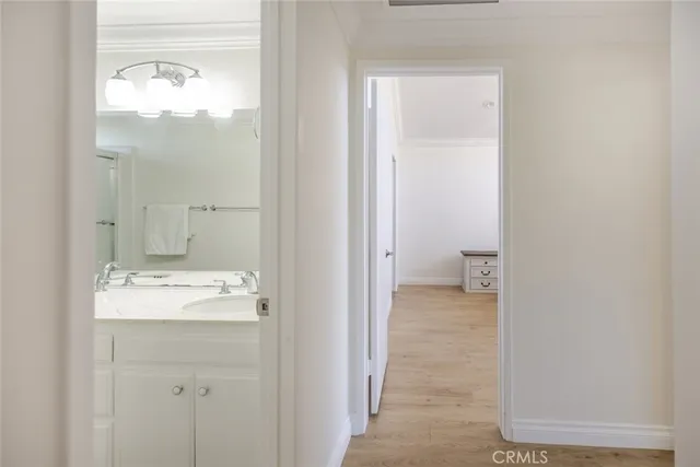 a spacious bedroom with a bed and a dresser