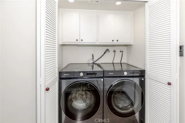a view of a patio with couches table and chairs and potted plants