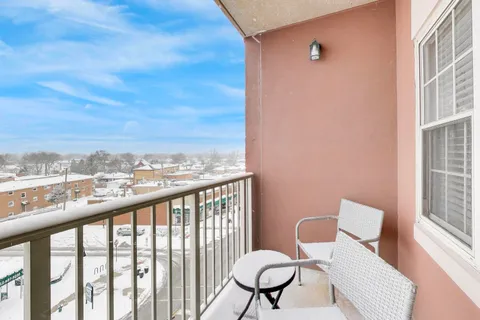a view of a balcony with chairs