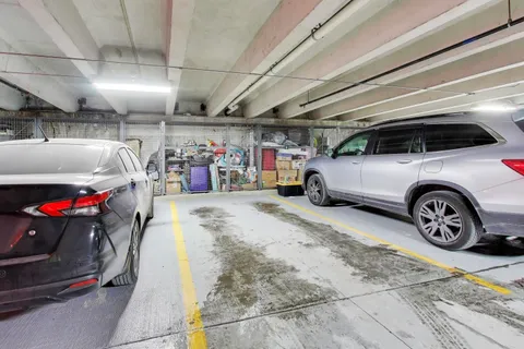a view of parking garage with cars and other equipment