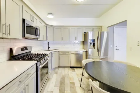 a kitchen with a stove a sink and a microwave