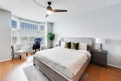 a bedroom with a bed a chandelier and a potted plant