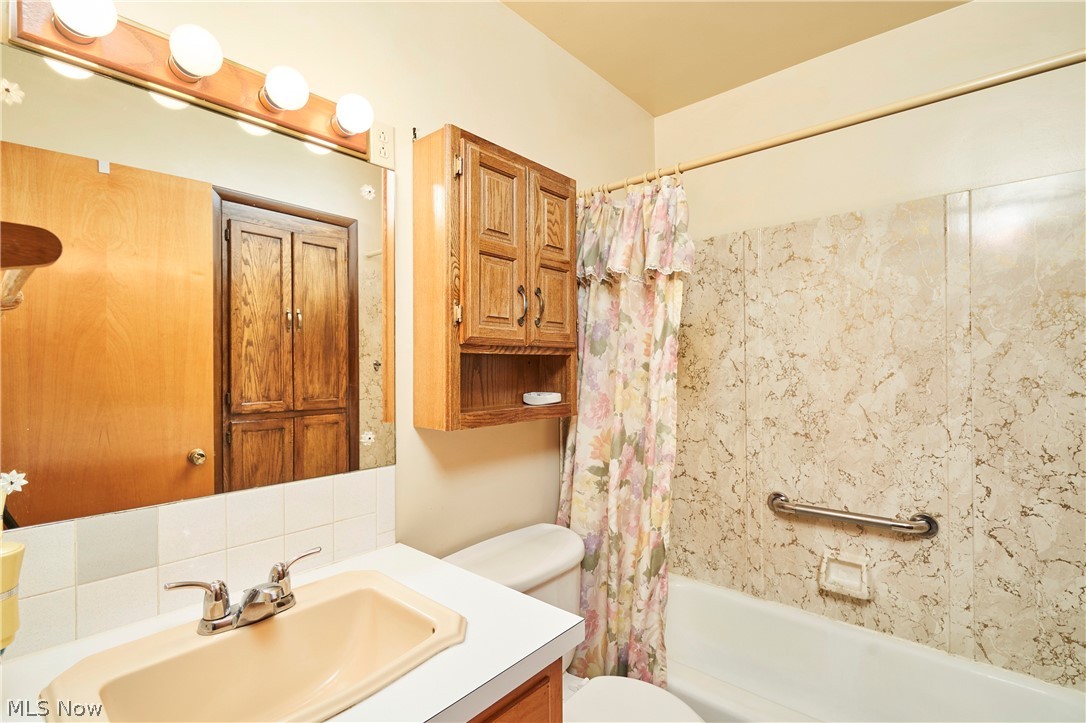 2375 Killian Road Akron, OH 44312 - Photo 9 of 19 Bathroom featuring a vanity with a drop-in sink, wall-mounted mirror, and overhead vanity lighting