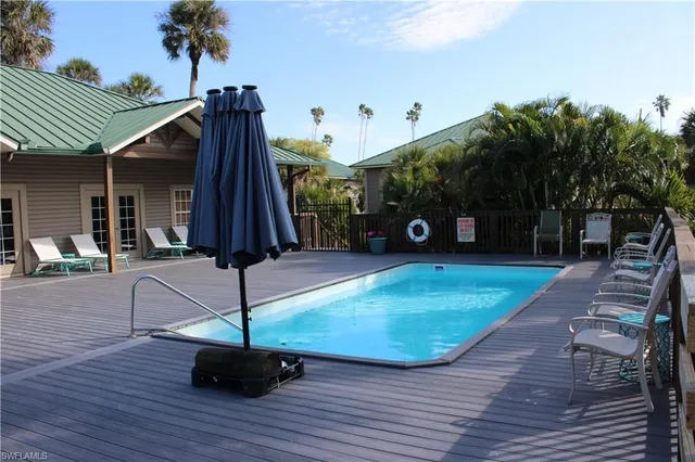 a view of a house with a wooden deck
