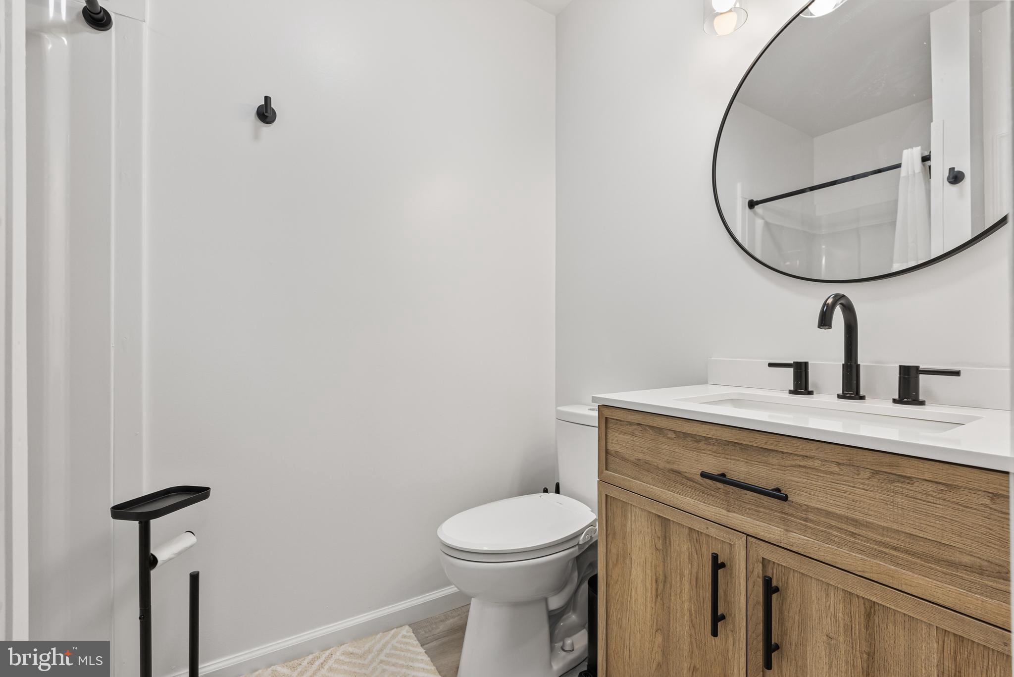 15 Ginger Drive Lumberton, NJ 08048 - Photo 23 of 30 a bathroom with a toilet a sink a mirror and vanity