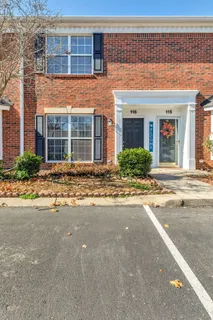 front view of a brick house with a small yard