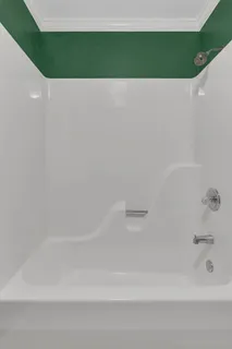 a bedroom with a bed and a couch next to a window