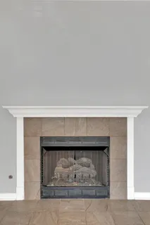 a kitchen with stainless steel appliances a dining table chairs and a refrigerator