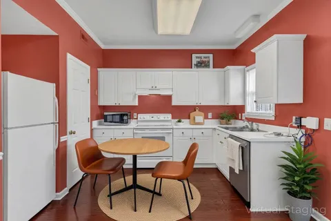 a kitchen with a stove a sink and a refrigerator
