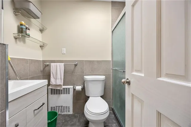 a white toilet sitting next to a bathroom sink