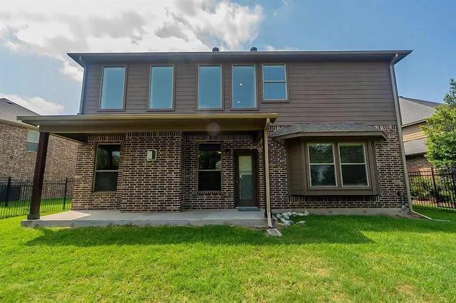 a view of a house with a yard and sitting area